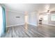 Bright living room with contemporary gray walls, modern wood-look floors, and open access to the kitchen at 925 Halstead St, Deltona, FL 32725