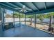 Screened in porch leading to backyard with shade at 925 Halstead St, Deltona, FL 32725