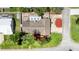 Aerial view of a home with a spacious backyard, paved patio, and lush landscaping at 952 Northbrook Dr, Ormond Beach, FL 32174