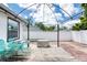 Backyard deck with patio set underneath an iron canopy, surrounded by a white privacy fence at 952 Northbrook Dr, Ormond Beach, FL 32174