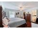 Bright bedroom with wood floors, walk-in closet, ceiling fan, and access to the bath at 952 Northbrook Dr, Ormond Beach, FL 32174