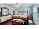 Cozy bedroom featuring an accent wall, wood floors, and lots of natural light at 952 Northbrook Dr, Ormond Beach, FL 32174