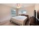 Cozy bedroom with a ceiling fan, large windows, and comfortable queen sized bed at 952 Northbrook Dr, Ormond Beach, FL 32174