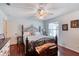 Bedroom features a large bed frame, wood floors, and lots of natural light at 952 Northbrook Dr, Ormond Beach, FL 32174
