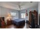 Stylish bedroom with a ceiling fan, hardwood floors, and large windows with bright daylight at 952 Northbrook Dr, Ormond Beach, FL 32174