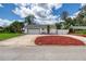 Long concrete driveway with large garage leading to backyard privacy gate at 952 Northbrook Dr, Ormond Beach, FL 32174