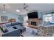 Comfortable living room with a fireplace, a modern ceiling fan, and stylish decor at 952 Northbrook Dr, Ormond Beach, FL 32174