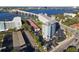 An aerial view shows the condo's exterior, parking, water views, and a bridge at 100 Silver Beach Ave # 608, Daytona Beach, FL 32118