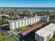 This aerial view shows a condo building near the beach with a tennis court and pool at 100 Silver Beach Ave # 608, Daytona Beach, FL 32118