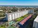 This aerial captures a condo's exterior, parking, pool, tennis court and beach views at 100 Silver Beach Ave # 608, Daytona Beach, FL 32118