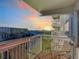 This balcony has seating and views of the water and a bridge at sunset at 100 Silver Beach Ave # 608, Daytona Beach, FL 32118