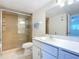 A well-lit bathroom features a glass door shower and a vanity at 100 Silver Beach Ave # 608, Daytona Beach, FL 32118