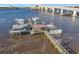 Aerial view of a private boat dock with multiple boat slips under a bridge at 100 Silver Beach Ave # 608, Daytona Beach, FL 32118