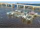 Aerial view of a private boat dock with multiple boats and slips under a bridge at 100 Silver Beach Ave # 608, Daytona Beach, FL 32118