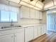 Updated kitchen with white cabinets, stainless steel sink, and updated laminate flooring at 100 Silver Beach Ave # 608, Daytona Beach, FL 32118