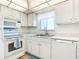 Bright kitchen featuring white appliances, cabinets, countertops, and an undermount sink at 100 Silver Beach Ave # 608, Daytona Beach, FL 32118