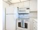 White kitchen featuring modern appliances, a countertop, and a ceiling fan with unique lighting at 100 Silver Beach Ave # 608, Daytona Beach, FL 32118