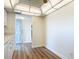 White kitchen with updated laminate flooring and stainless steel sink near the entry door at 100 Silver Beach Ave # 608, Daytona Beach, FL 32118