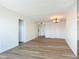 Spacious living area featuring wood floors, closet space, and a chandelier at 100 Silver Beach Ave # 608, Daytona Beach, FL 32118