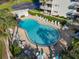 Overhead view of a kidney-shaped pool area with lounge chairs and manicured landscaping at 100 Silver Beach Ave # 608, Daytona Beach, FL 32118