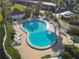 Overhead view of a kidney-shaped pool with lounge chairs, umbrellas, and a small spa at 100 Silver Beach Ave # 608, Daytona Beach, FL 32118