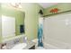 Bathroom features a granite vanity, framed mirror, dinosaur decor, and tub with blue curtain at 1005 Flagler Ave, Edgewater, FL 32132