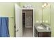 Bright bathroom featuring single sink and doorway to another bedroom at 1005 Flagler Ave, Edgewater, FL 32132