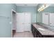 Bright bathroom featuring double sinks, granite countertops, and a large mirror at 1005 Flagler Ave, Edgewater, FL 32132