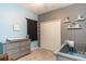 Bedroom featuring a crib, changing table, and neutral decor at 1005 Flagler Ave, Edgewater, FL 32132