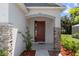 Stylish home entrance with brick columns, modern door, and manicured landscaping at 1005 Flagler Ave, Edgewater, FL 32132