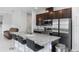 Modern kitchen with granite counters, stainless appliances, seating at the island and open floor plan at 1005 Flagler Ave, Edgewater, FL 32132