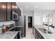 Modern kitchen featuring stainless steel appliances, granite countertops, and dark wood cabinetry at 1005 Flagler Ave, Edgewater, FL 32132