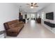 Spacious living room open to the kitchen with tile floors and neutral walls at 1005 Flagler Ave, Edgewater, FL 32132