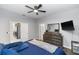 Beautiful main bedroom featuring dark wood furniture, ceiling fan, and entry to kitchen at 1005 Flagler Ave, Edgewater, FL 32132