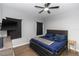 Charming main bedroom features ceiling fan, dark wood furniture, and plush bedding at 1005 Flagler Ave, Edgewater, FL 32132