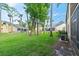 Lush green backyard with mature trees, offering privacy and a serene outdoor space at 102 Bob White Ct # 102C, Daytona Beach, FL 32119