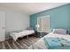 Bedroom featuring two twin beds with coordinated decor and wood look floors at 102 Bob White Ct # 102C, Daytona Beach, FL 32119