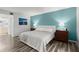 Bedroom featuring soothing blue walls, two beds, and wood look flooring at 102 Bob White Ct # 102C, Daytona Beach, FL 32119