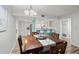Cozy dining area with a wooden table and chairs, opening to a fully equipped kitchen and bright breakfast bar at 102 Bob White Ct # 102C, Daytona Beach, FL 32119
