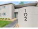Inviting condo exterior featuring a well-maintained facade, lush landscaping, and clearly visible unit number 102 at 102 Bob White Ct # 102C, Daytona Beach, FL 32119