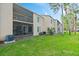 A well-maintained condo building with a spacious lawn and screened lanais at 102 Bob White Ct # 102C, Daytona Beach, FL 32119
