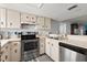 Functional kitchen with stainless steel appliances, ample counter space, and classic cabinetry providing a cozy cooking area at 102 Bob White Ct # 102C, Daytona Beach, FL 32119