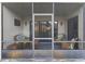 An inviting screened patio featuring charming wicker furniture and a decorative rug at 102 Bob White Ct # 102C, Daytona Beach, FL 32119