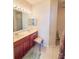 Bathroom with dual sinks, large mirror with vanity lights and separate toilet area at 103 Manor View Ln, Deland, FL 32724