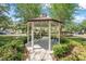 Charming gazebo with seating, providing a tranquil spot to relax and enjoy the surrounding landscape at 103 Manor View Ln, Deland, FL 32724