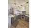Modern kitchen with gray cabinets, quartz countertops, stainless steel appliances, and open shelving at 103 Manor View Ln, Deland, FL 32724