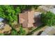 Overhead shot of the house showing the roof, driveway, landscaping, and surrounding mature trees at 1057 Shady Hollow Dr, Deland, FL 32724
