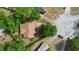 An aerial view of a well-maintained home with a brown roof in a mature, tree-lined neighborhood at 1057 Shady Hollow Dr, Deland, FL 32724