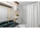 This bathroom features a shower/bath combo and green marble sink at 1057 Shady Hollow Dr, Deland, FL 32724