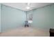 This light and airy bedroom features a large window and light blue paint at 1057 Shady Hollow Dr, Deland, FL 32724